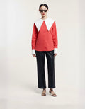 Model wearing a red and white top with black pants on a white background ISHQ E AMORE
