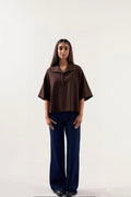 Woman wearing a brown blouse and blue pants on a white background ishq e amore